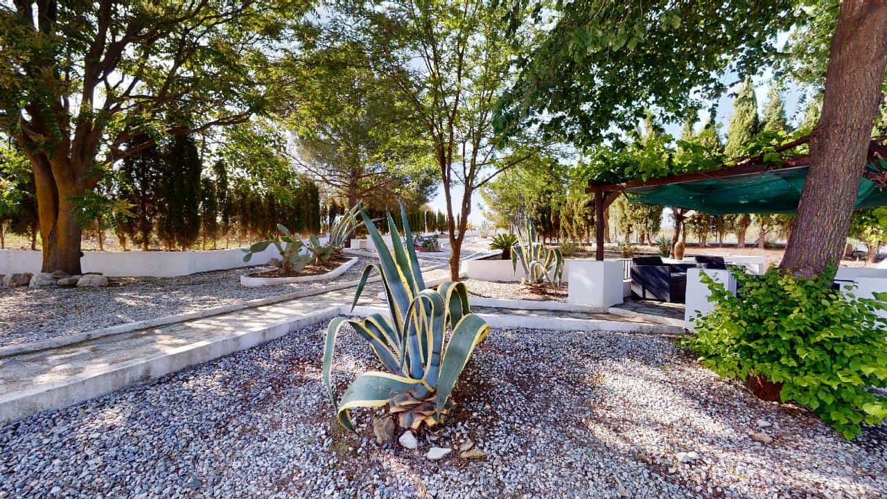 Boutique hotel for sale in Caniles, Granada, Spain, featuring a charming outdoor garden and relaxing.