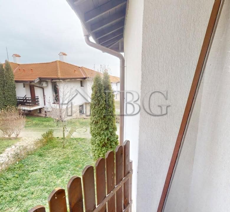 Bright view of the apartment balcony overlooking lush green gardens in Kosharitsa.