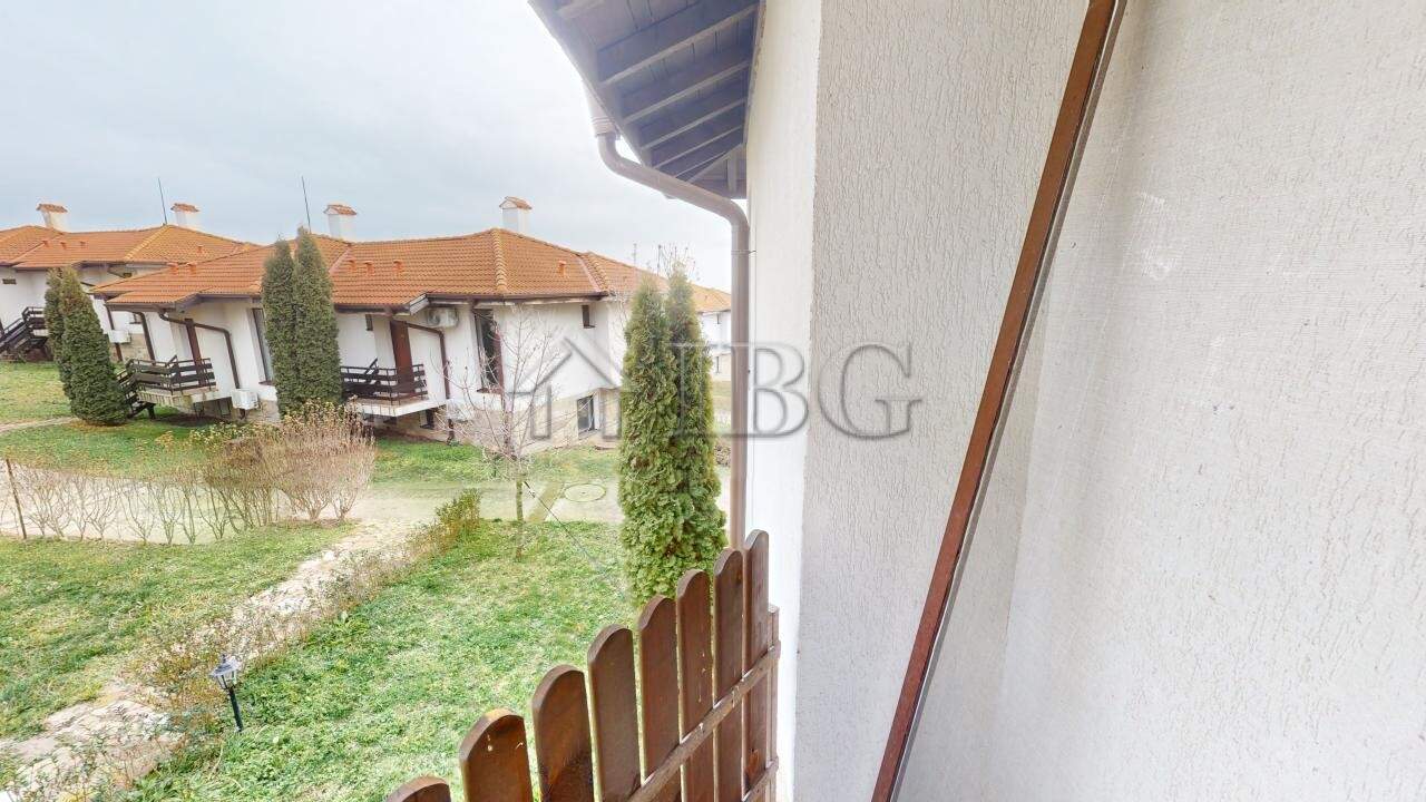 Bright view of the apartment balcony overlooking lush green gardens in Kosharitsa.