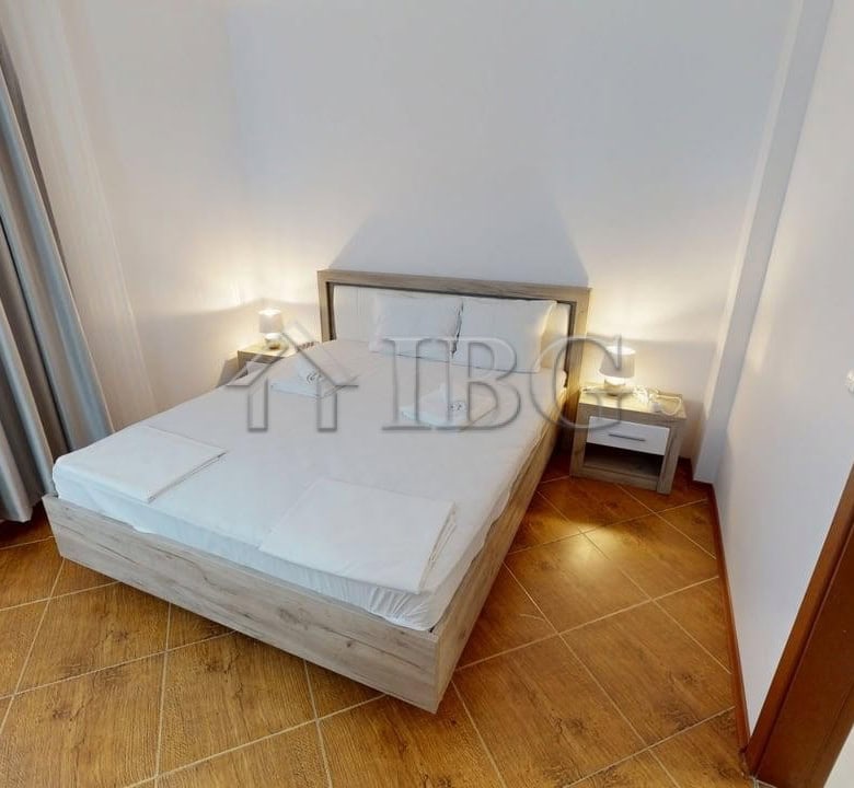 Bedroom with a comfortable double bed, bedside tables, and elegant decor.