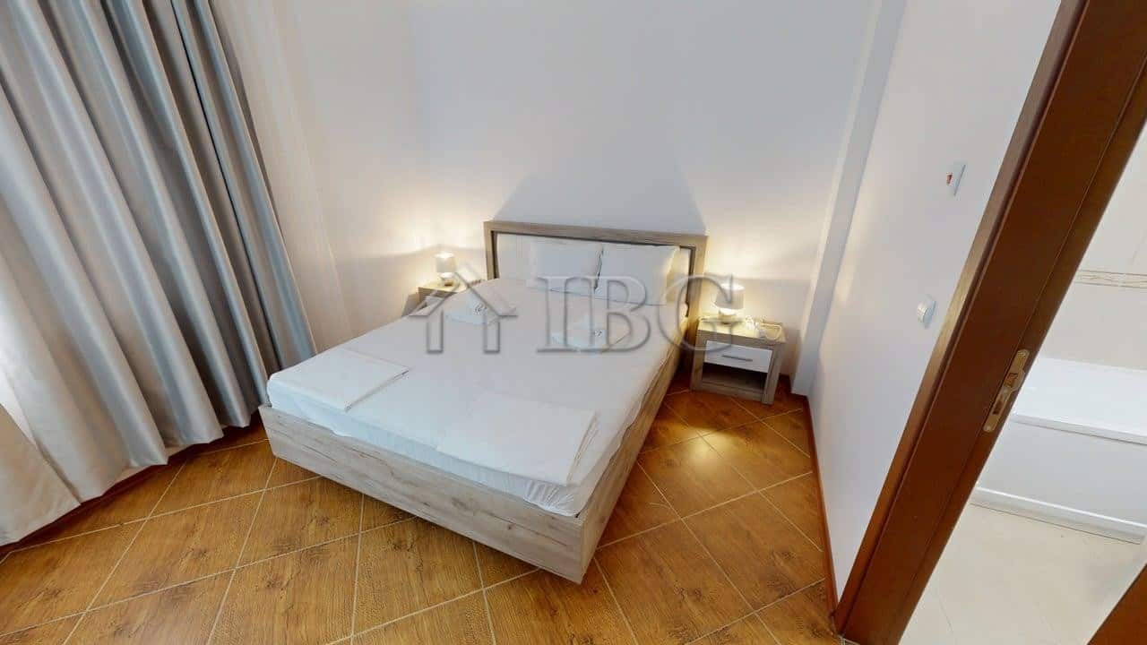 Bedroom with a comfortable double bed, bedside tables, and elegant decor.