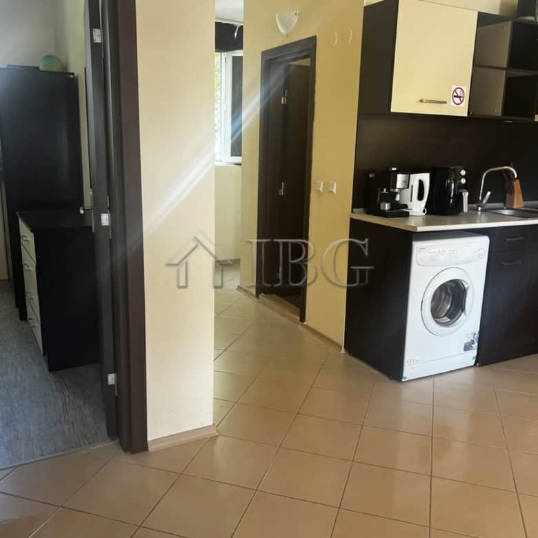 Bright interior of a 2-bedroom apartment with modern kitchen and pool view in Sunset Beach 3, Sunny.