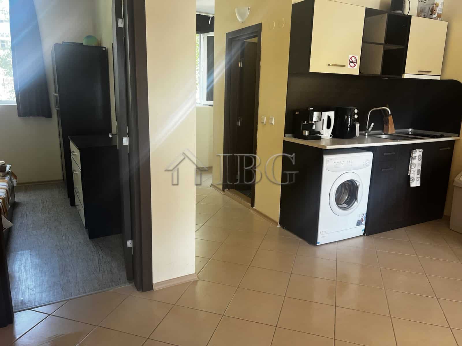 Bright interior of a 2-bedroom apartment with modern kitchen and pool view in Sunset Beach 3, Sunny.