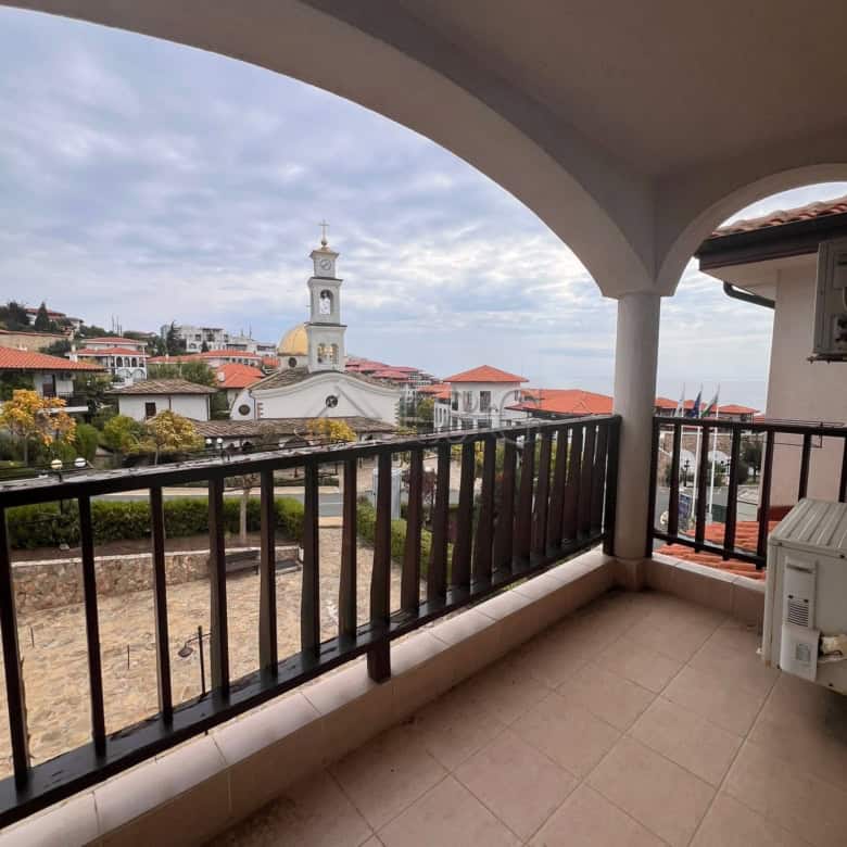 Balcony of a two-bedroom apartment overlooking the sea and town in Sveti Vlas, Bulgaria.