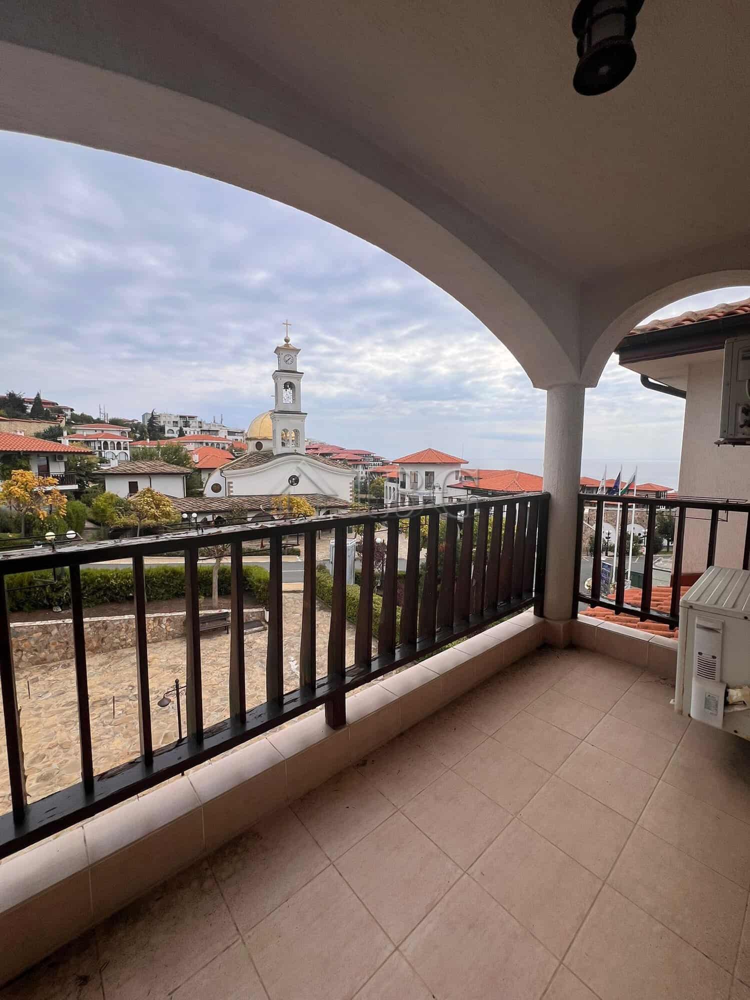 Balcony of a two-bedroom apartment overlooking the sea and town in Sveti Vlas, Bulgaria.