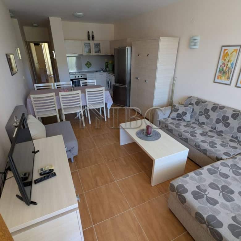Spacious living room with sofa, TV, and open-plan kitchen in Sveti Vlas.
