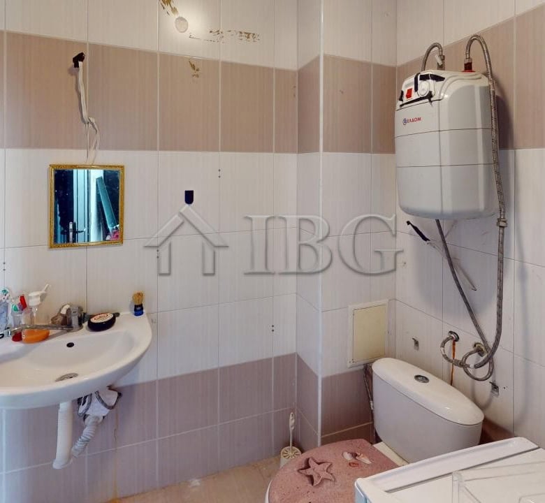 Bathroom with sink, mirror, and toilet in a modern apartment.
