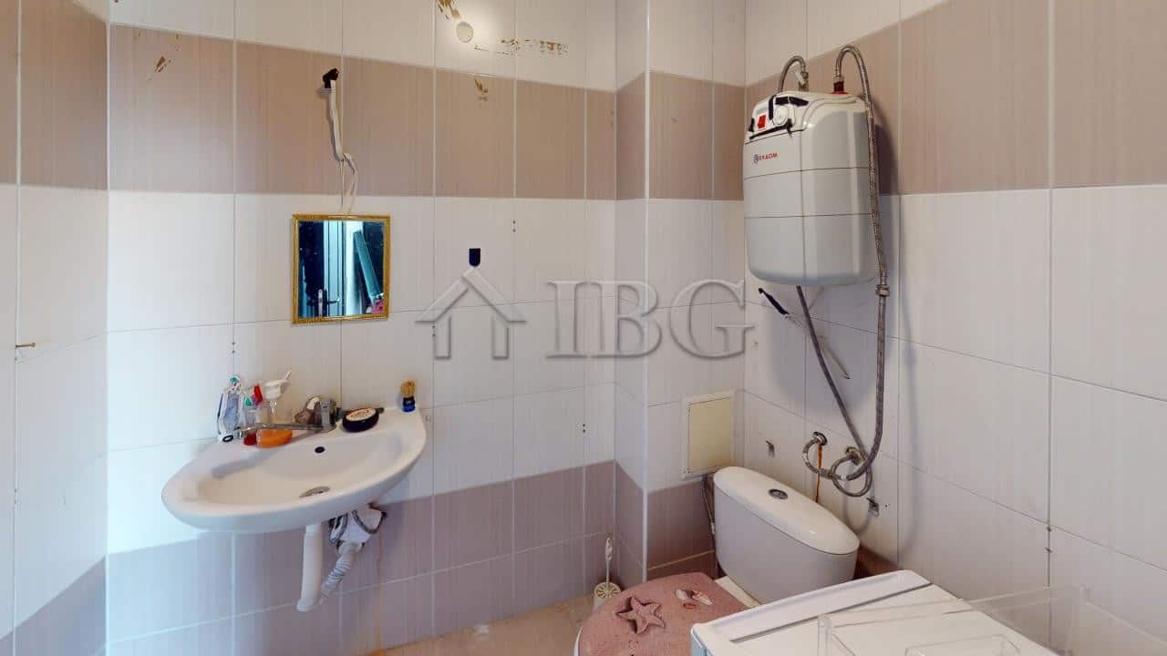 Bathroom with sink, mirror, and toilet in a modern apartment.
