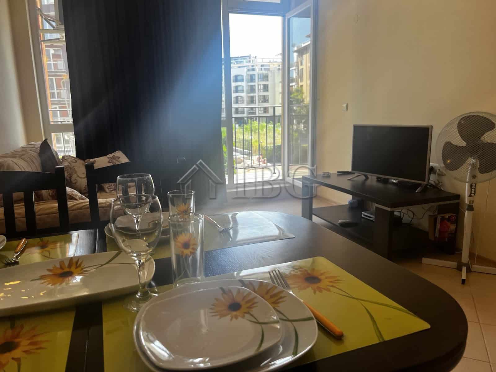 Bright living room with large balcony overlooking pool in Sunset Beach 3, Sunny Beach.