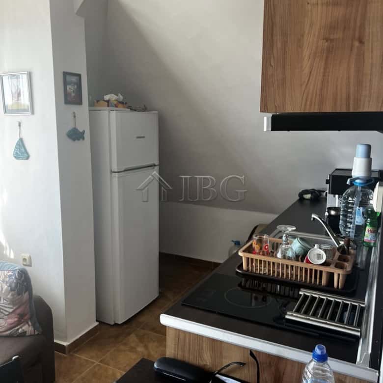 Apartment with sea view in Ravda, Bulgaria, featuring a compact kitchen and modern amenities.