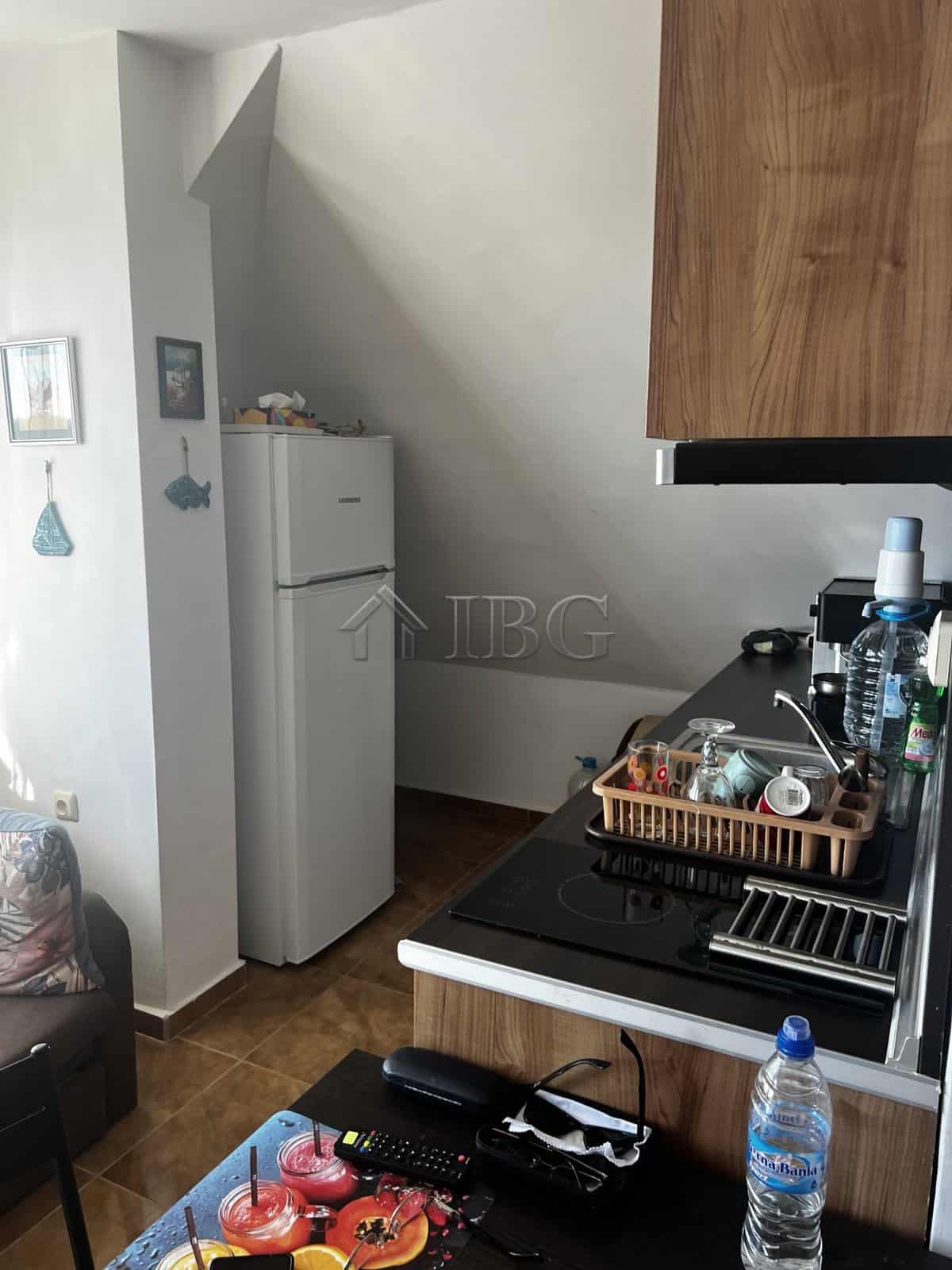 Apartment with sea view in Ravda, Bulgaria, featuring a compact kitchen and modern amenities.