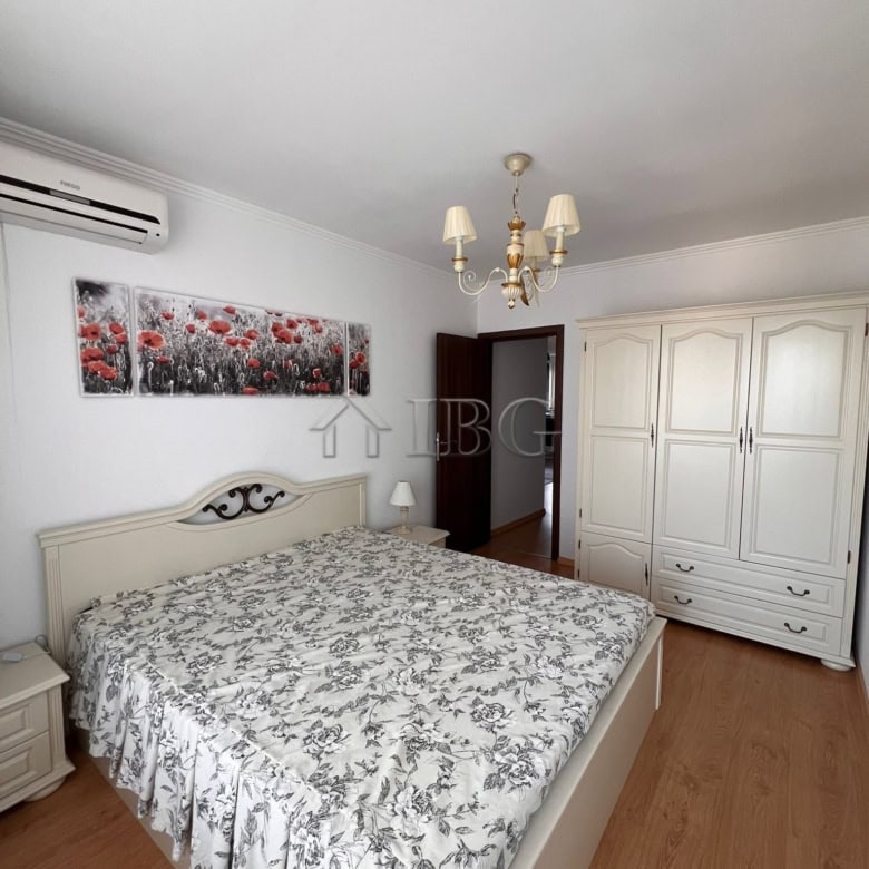 Spacious bedroom with a large bed, floral bedding, and elegant decor in Villa Antorini.
