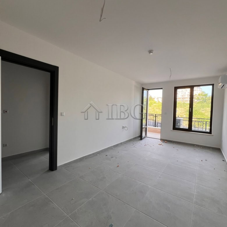 Modern one-bedroom apartment in Sveti Vlas with spacious living area and large windows.