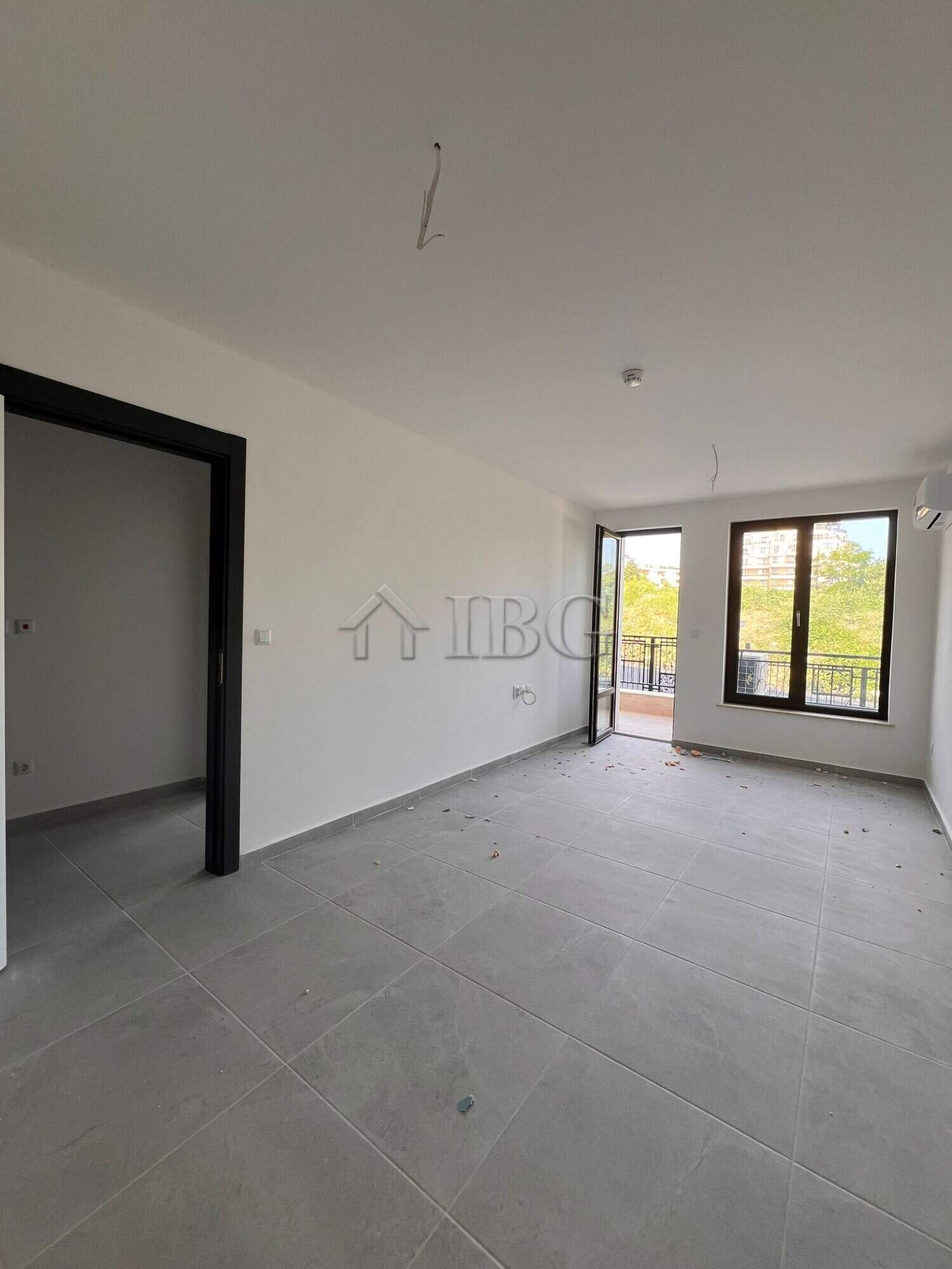 Modern one-bedroom apartment in Sveti Vlas with spacious living area and large windows.