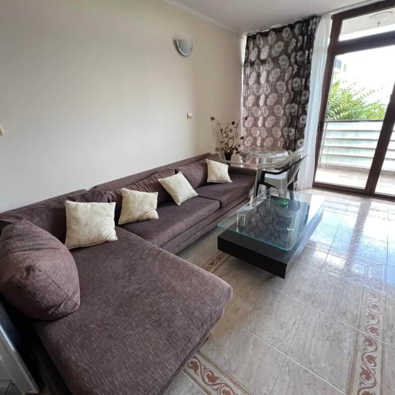 Bright living room with sofa and partial sea view in Sveti Vlas.