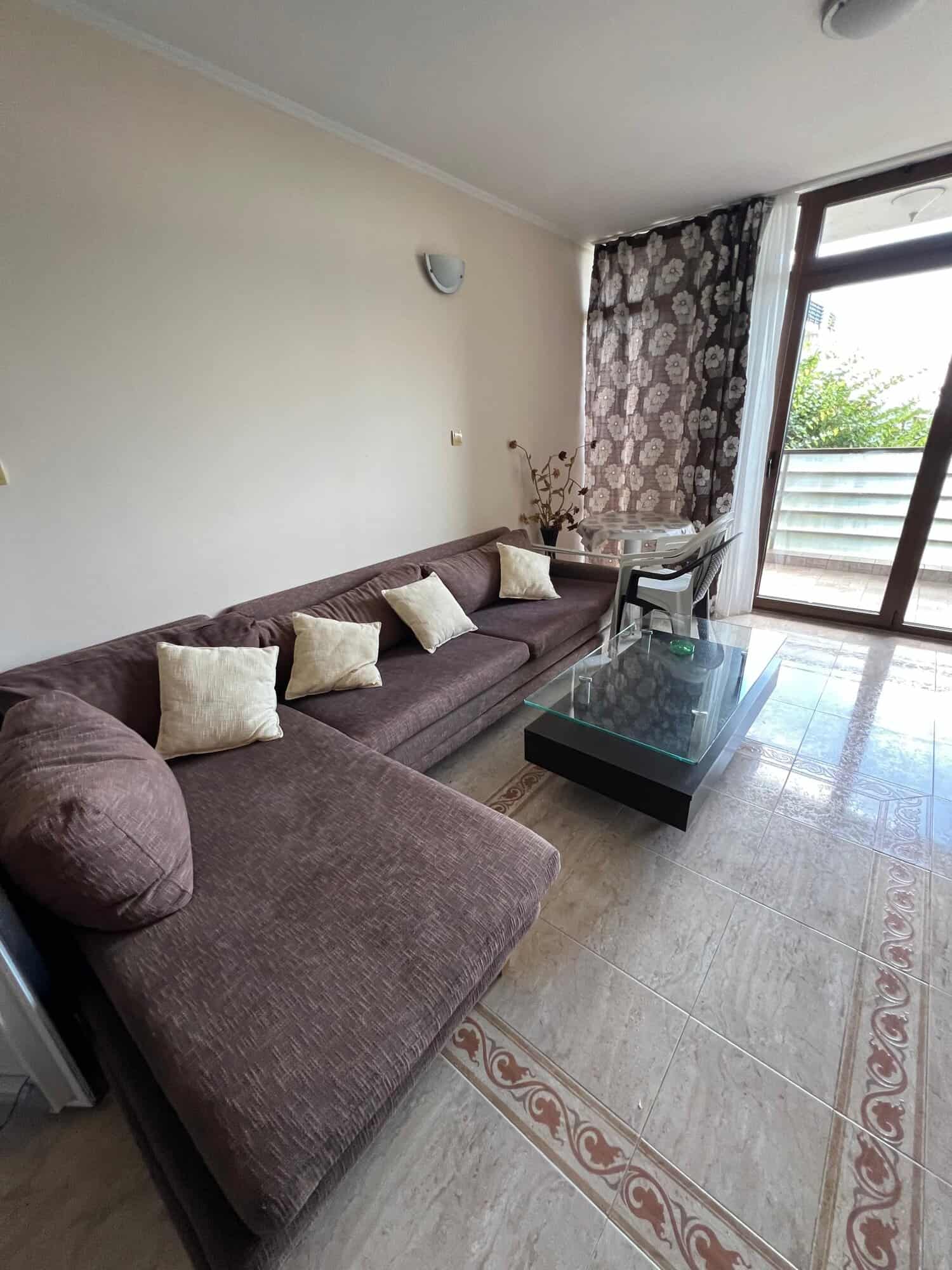 Bright living room with sofa and partial sea view in Sveti Vlas.