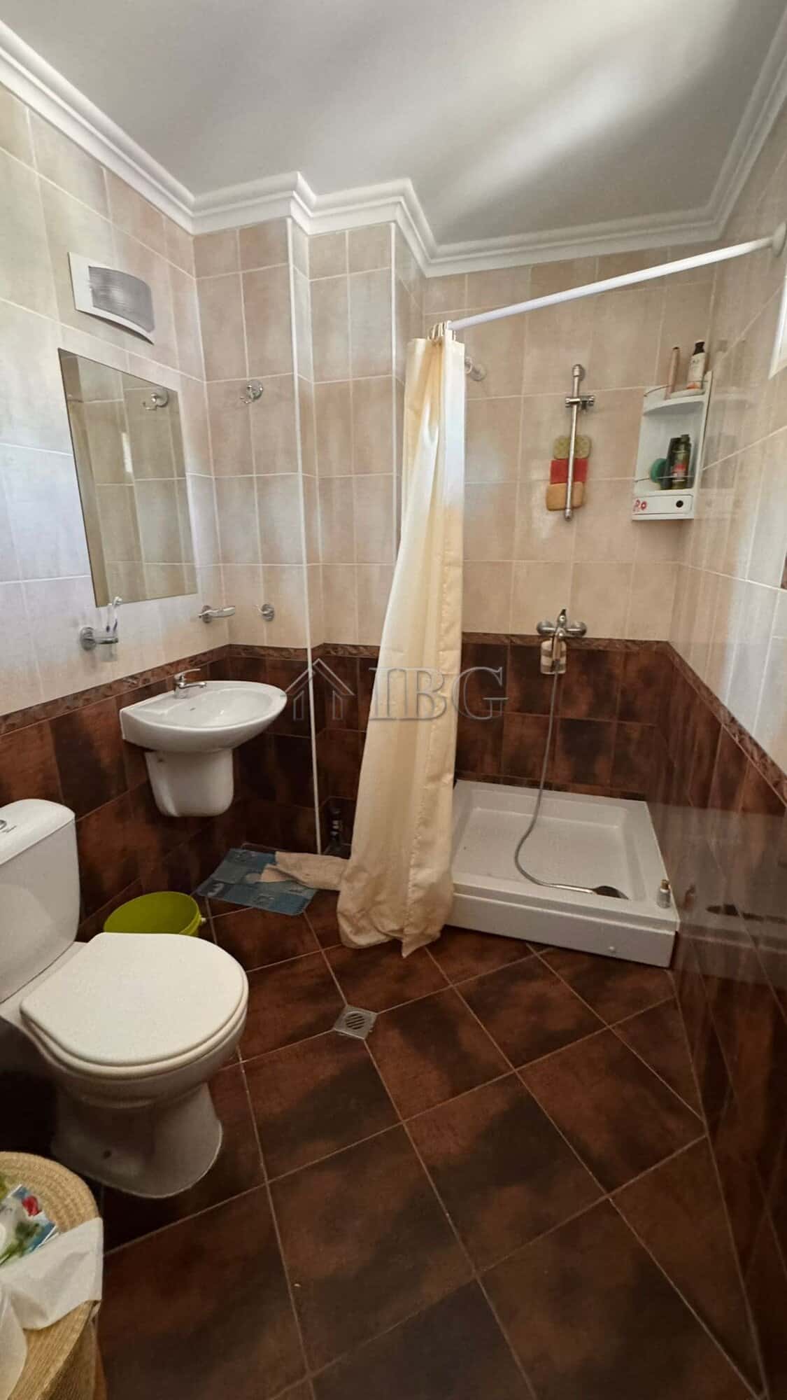 Bathroom with shower, toilet, and sink in a modern Sveti Vlas apartment.