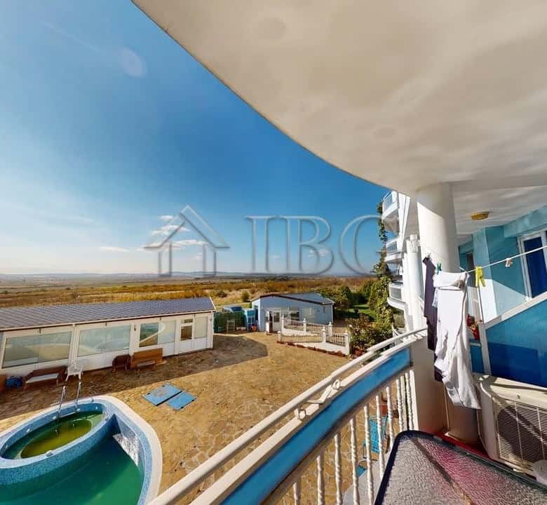 Modern apartment balcony overlooking pool and sea in Kosharitsa, Bulgaria.