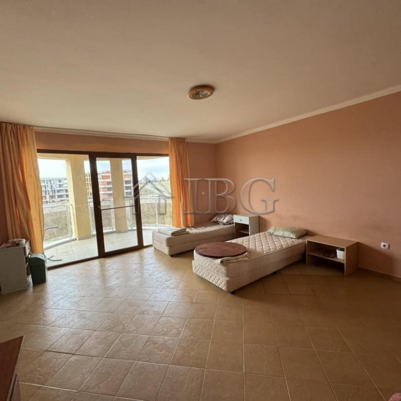 Bright living room with large windows and balcony access in Kosharitsa property.