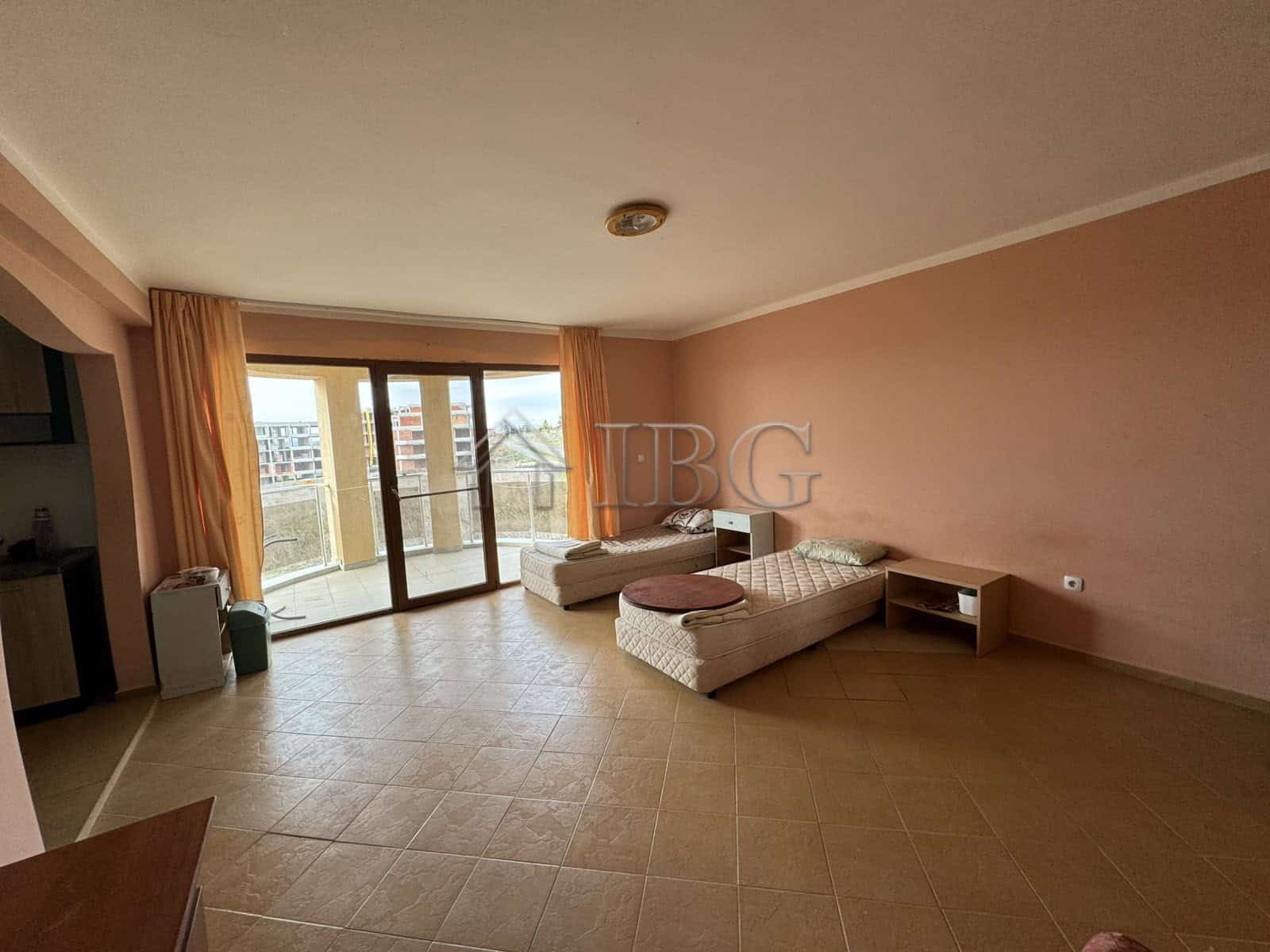 Bright living room with large windows and balcony access in Kosharitsa property.
