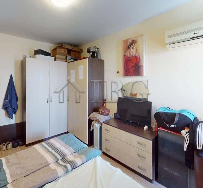 Interior view of a bedroom in a Kosharitsa apartment with wardrobe and air conditioning.