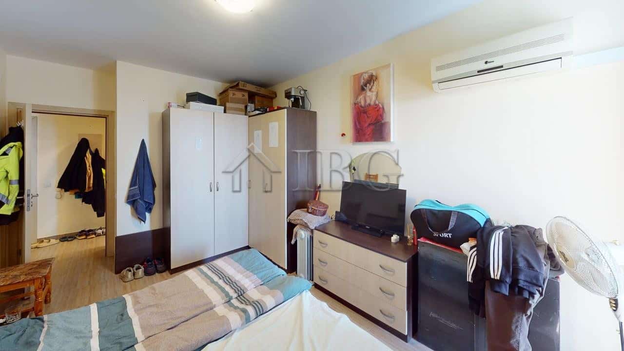 Interior view of a bedroom in a Kosharitsa apartment with wardrobe and air conditioning.