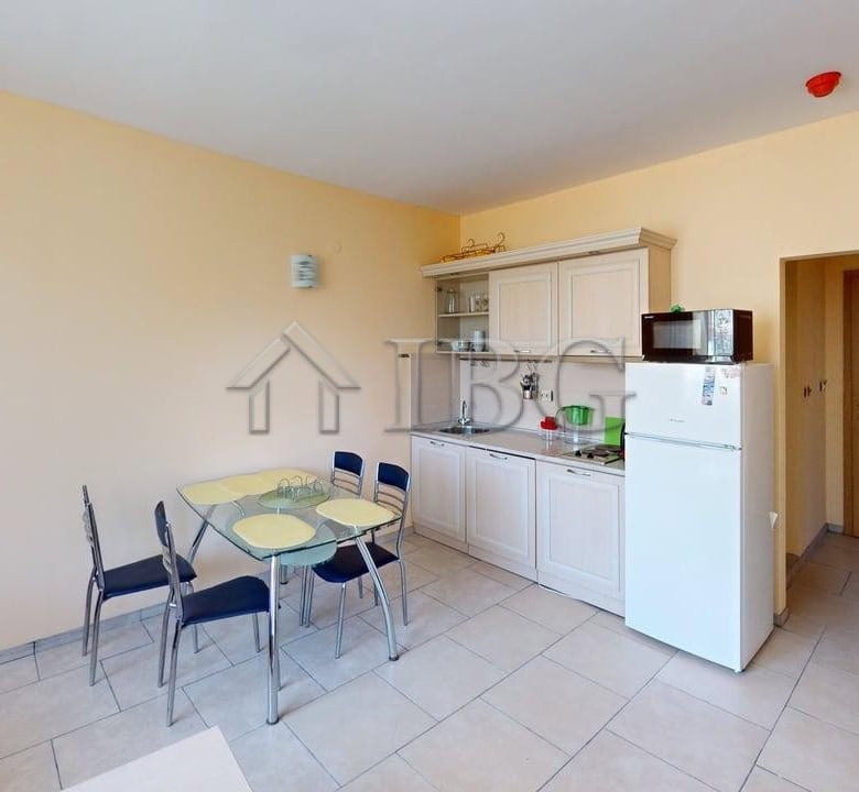 Bright 1-bedroom apartment in Avalon Complex, Sunny Beach, with modern kitchen and dining area.