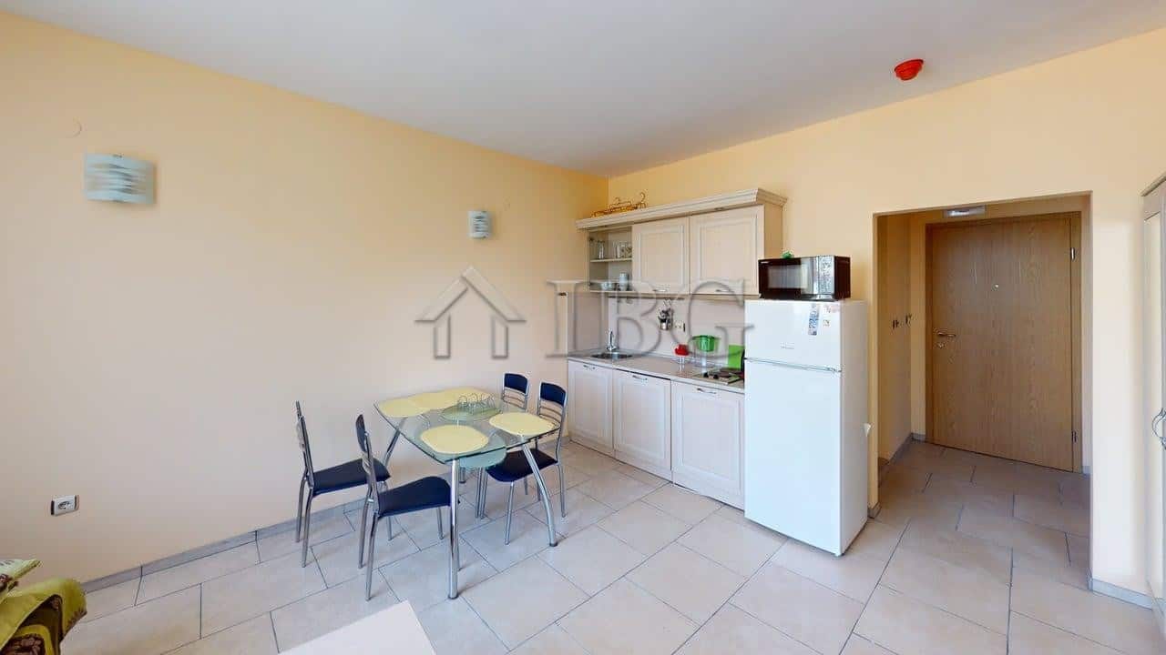 Bright 1-bedroom apartment in Avalon Complex, Sunny Beach, with modern kitchen and dining area.