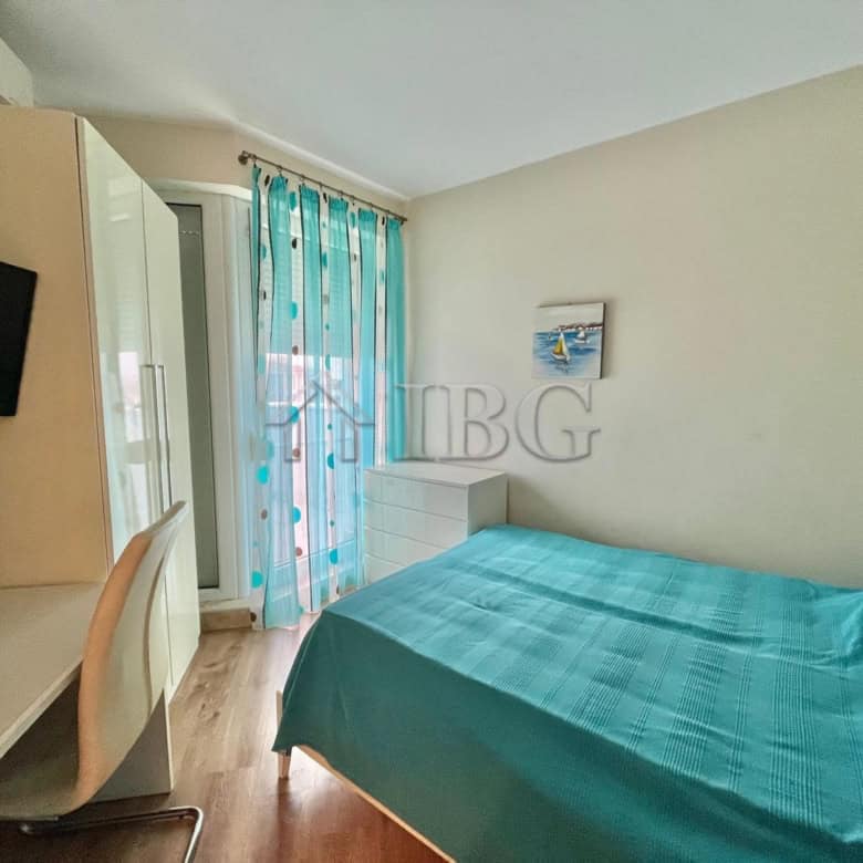 Bright bedroom with large bed and sea view in Ravda apartment.
