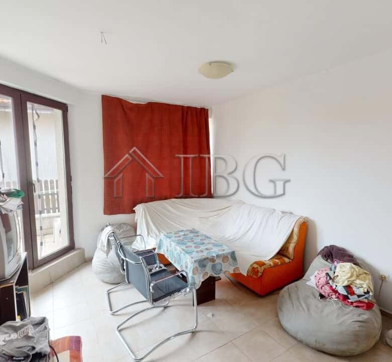 Bright living room with large windows and balcony access in Bay View Villas, Kosharitsa.