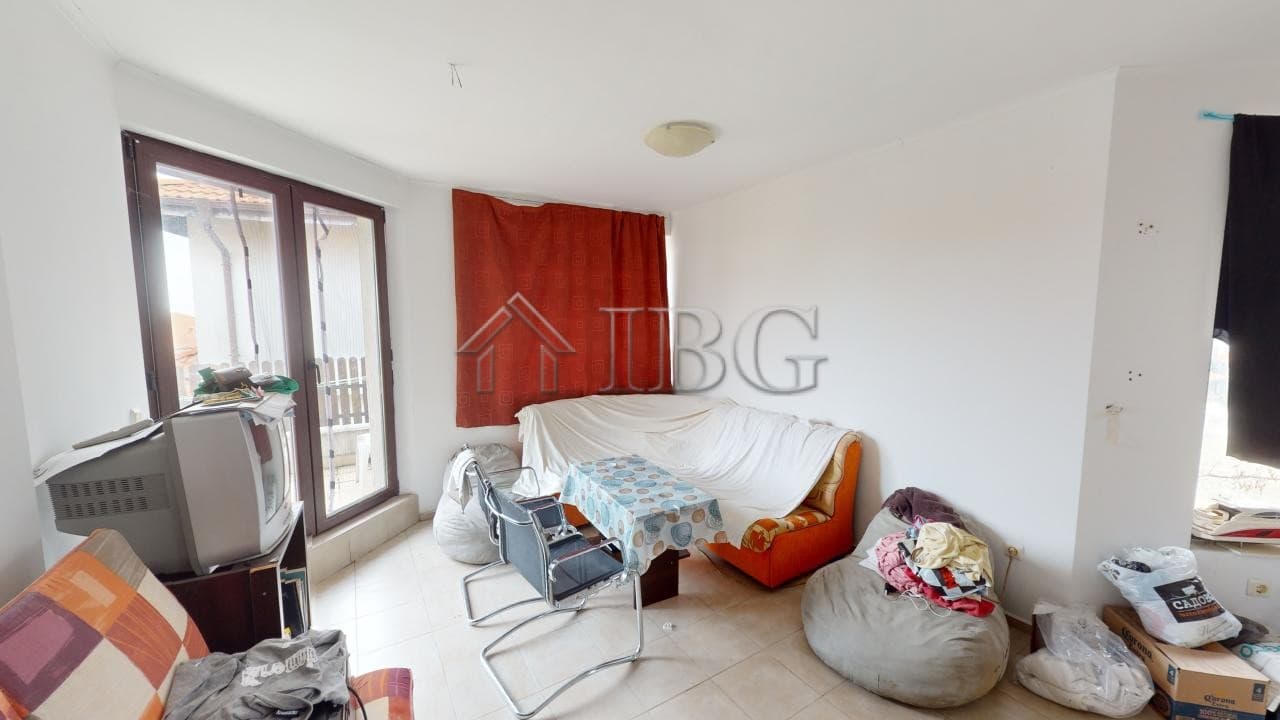 Bright living room with large windows and balcony access in Bay View Villas, Kosharitsa.