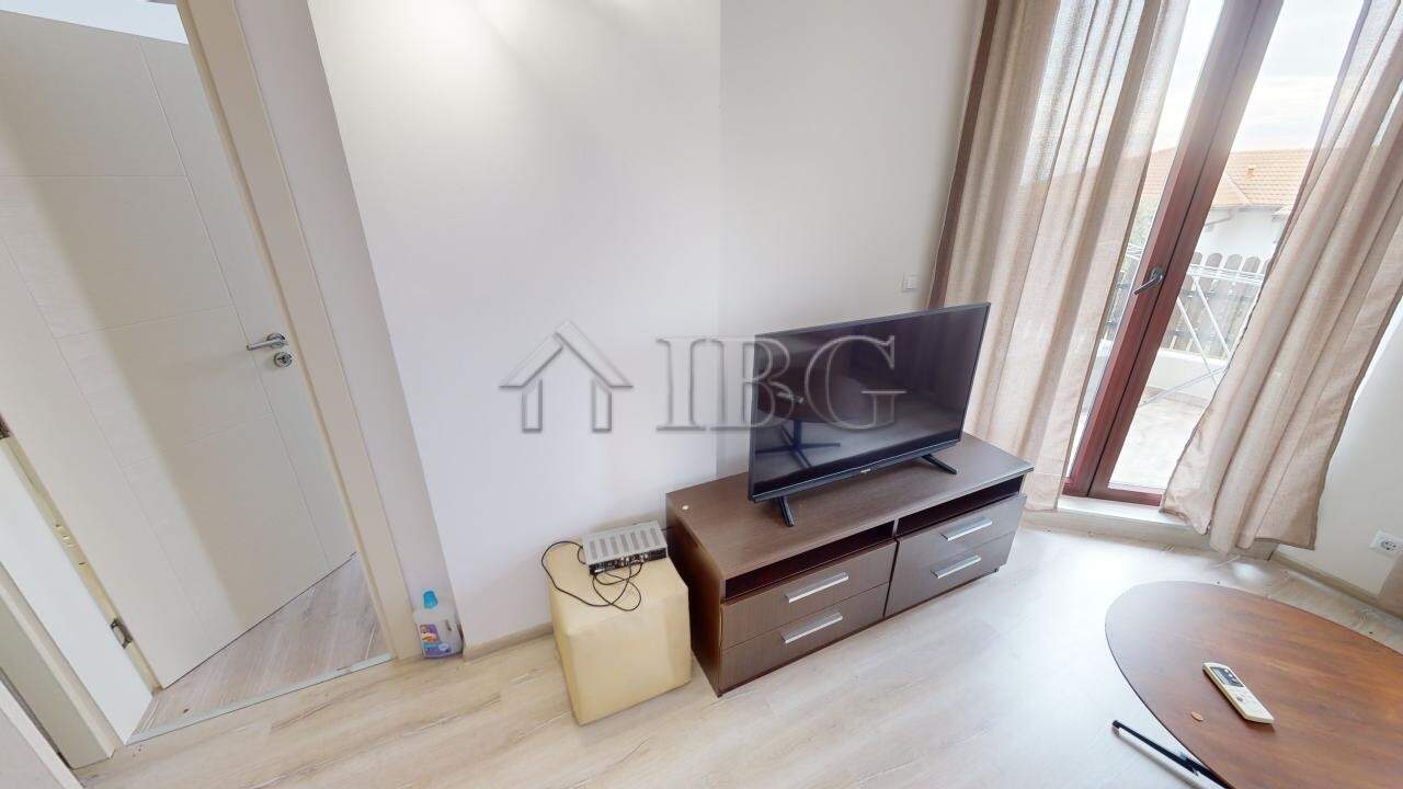 Bright living room with TV and balcony in Bay View Villas, Kosharitsa.