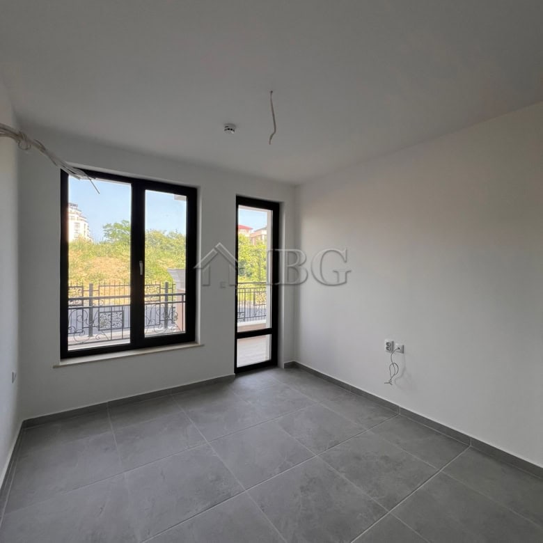 Bright empty room with large windows in Sveti Vlas apartment.