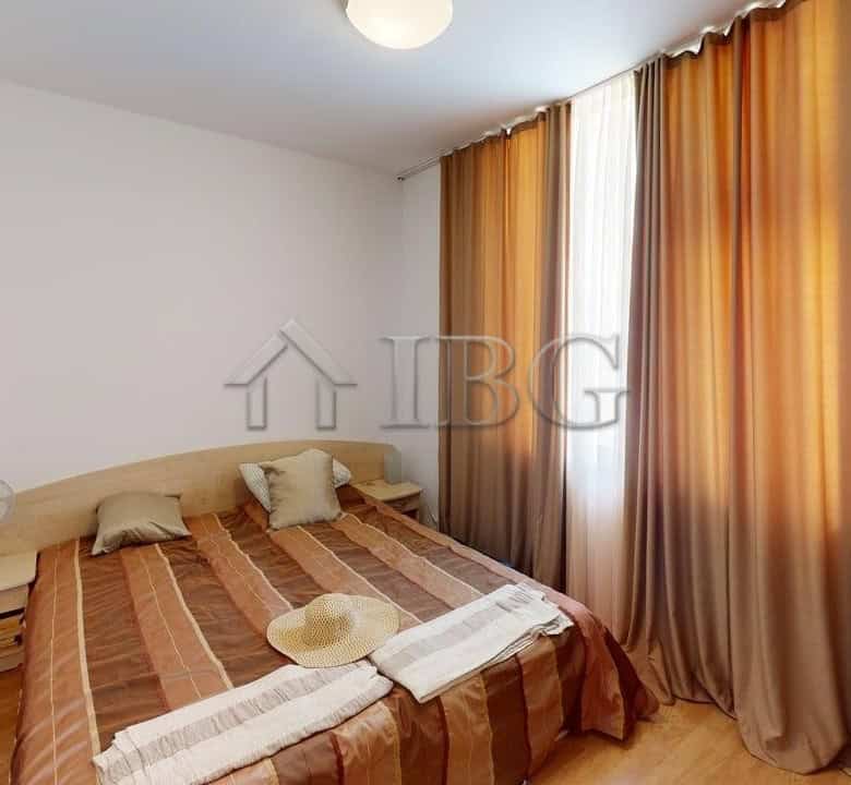Bright 2-bedroom apartment with large windows and curtains in Sunny Beach.