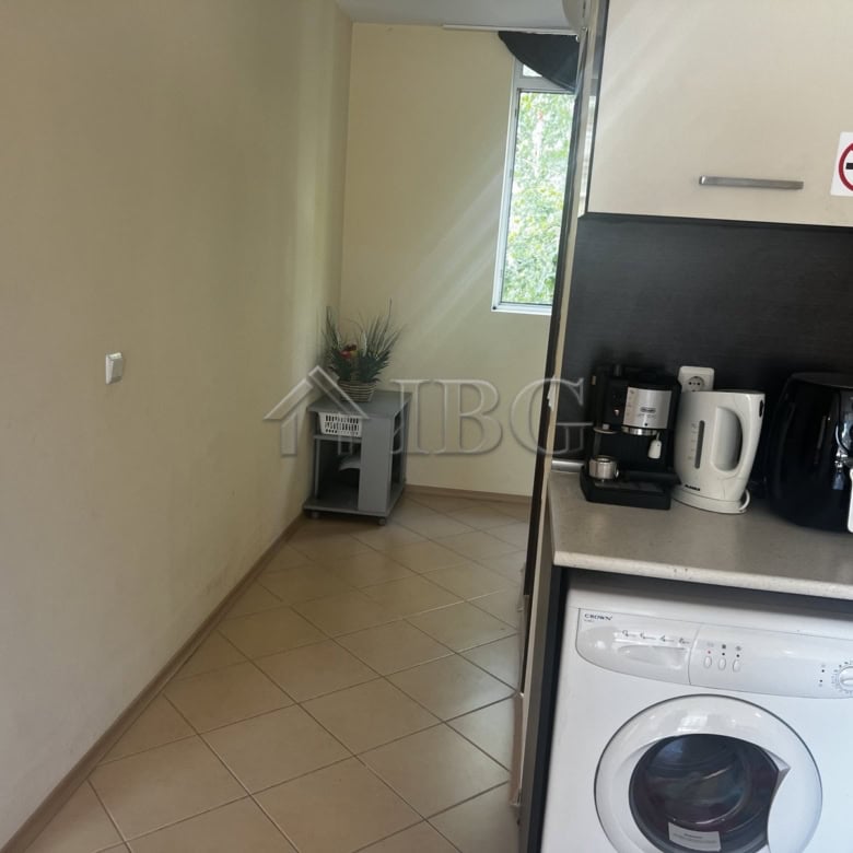 Modern kitchen with coffee maker and washing machine in Sunset Beach 3, Sunny Beach, Bulgaria.