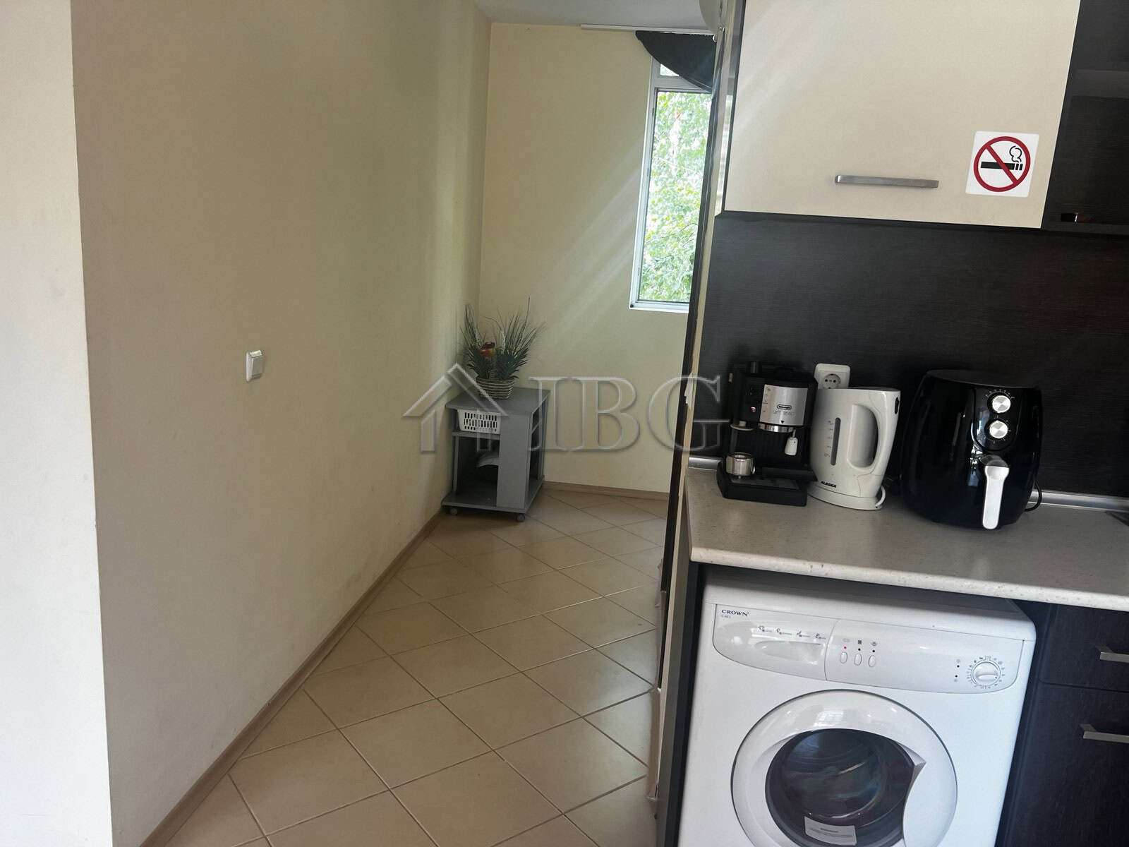 Modern kitchen with coffee maker and washing machine in Sunset Beach 3, Sunny Beach, Bulgaria.
