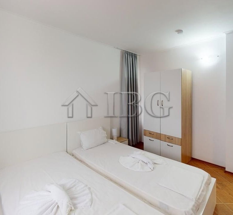 Bright, airy bedroom with a double bed, wardrobe, and natural light.