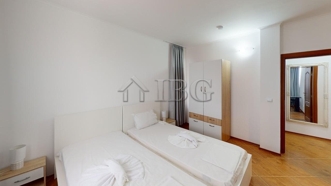Bright, airy bedroom with a double bed, wardrobe, and natural light.