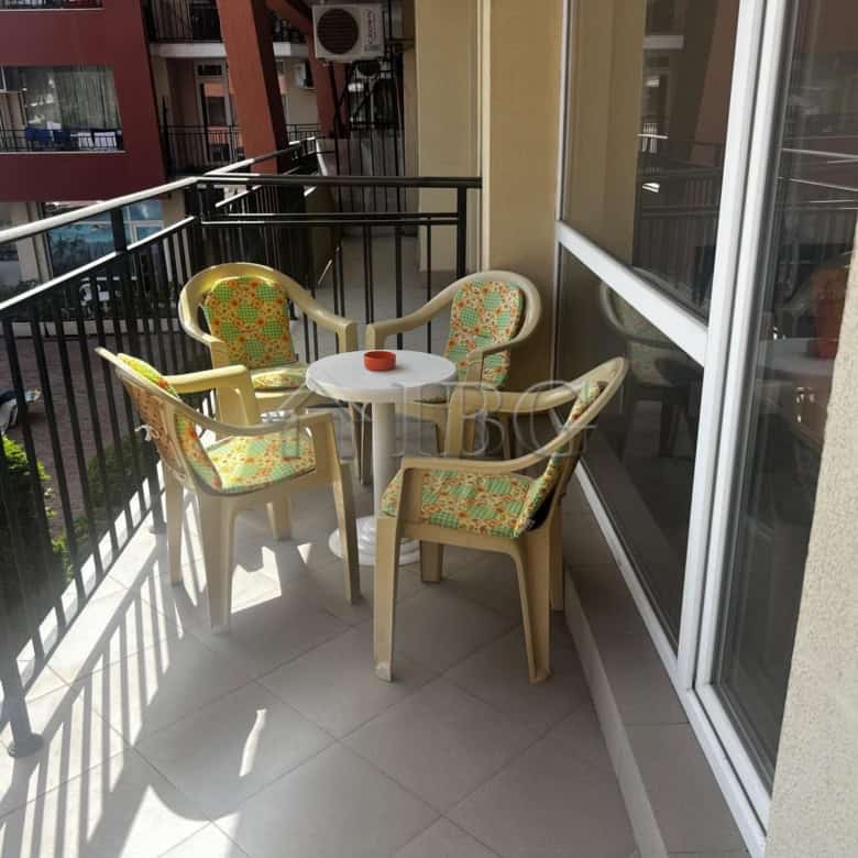 Balcony with outdoor seating overlooking pool in Sunset Beach 3, Sunny Beach.