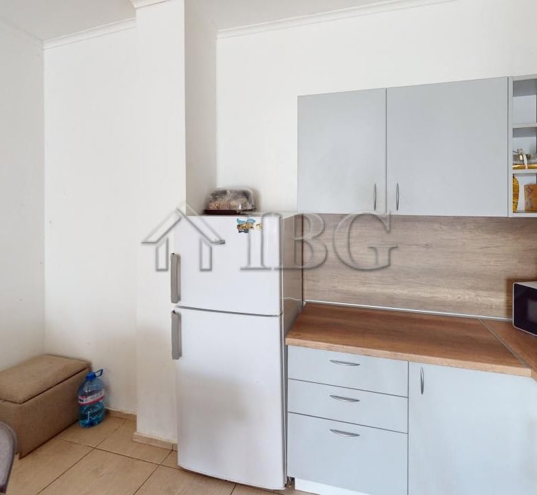Bright kitchen with white cabinets and wooden countertops in Bay View Villas, Kosharitsa.
