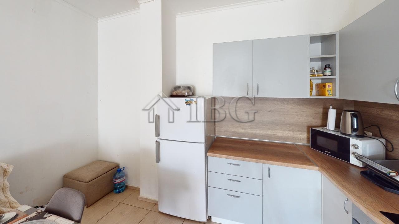 Bright kitchen with white cabinets and wooden countertops in Bay View Villas, Kosharitsa.