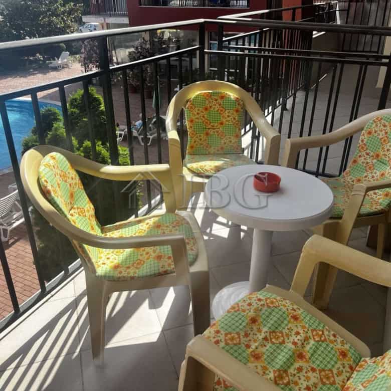Balcony with colorful chairs overlooking pool at Sunset Beach 3, Sunny Beach.