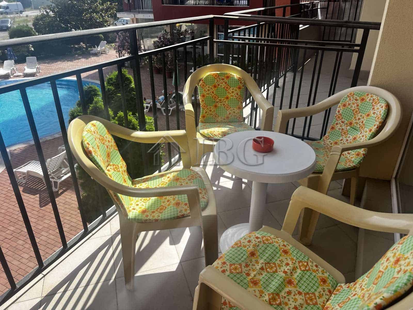Balcony with colorful chairs overlooking pool at Sunset Beach 3, Sunny Beach.