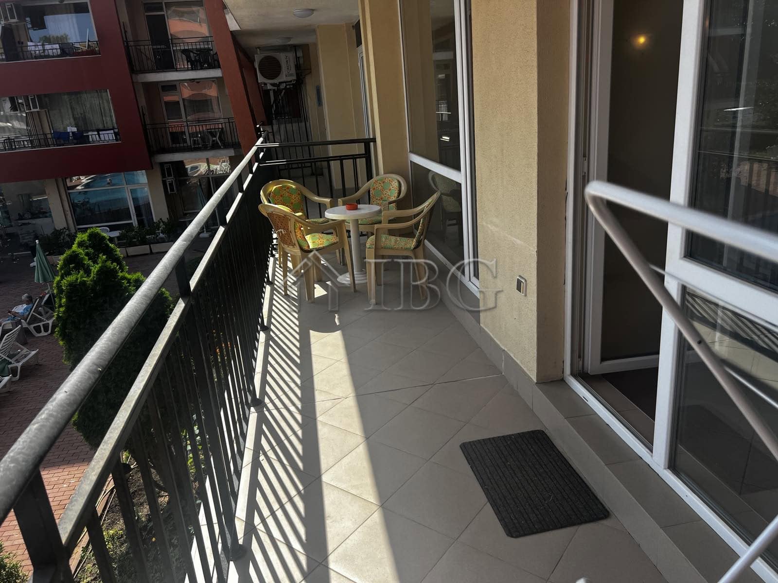Balcony overlooking pool area at Sunset Beach 3, Sunny Beach, with outdoor seating.