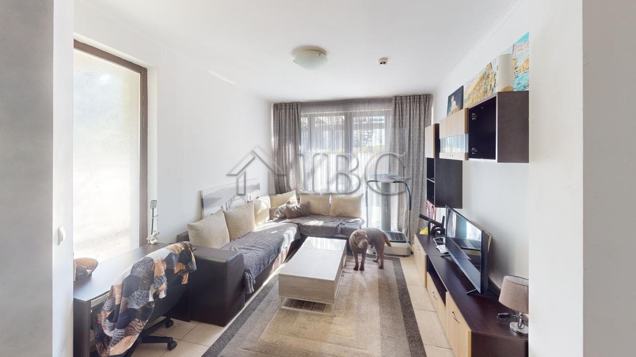 Bright living room with large windows and modern furnishings in Bay View Villas, Kosharitsa.