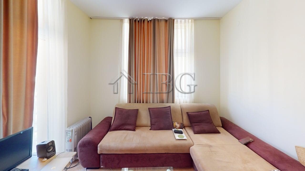 Bright living room with sofa, cushions, and curtains in Barco Del Sol, Sunny Beach.