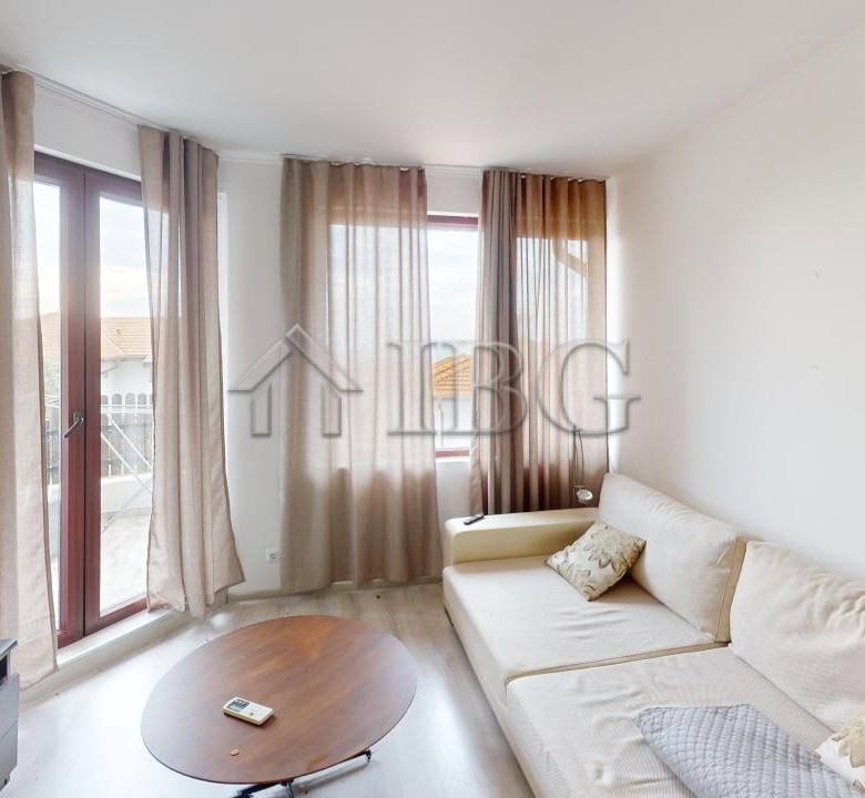 Bright living room with large windows and natural light in Kosharitsa.
