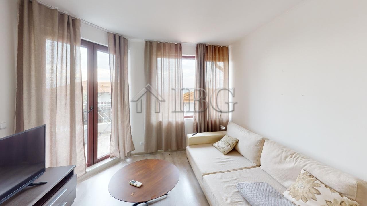 Bright living room with large windows and natural light in Kosharitsa.