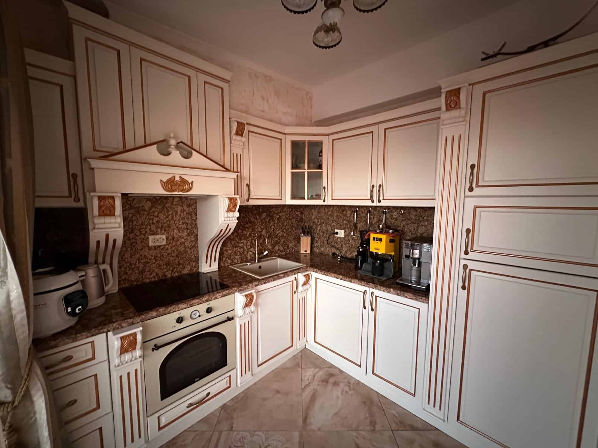 Apartment kitchen with modern appliances and elegant cabinetry in Venera Palace, Sunny Beach.