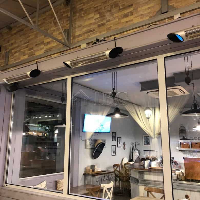 Elegant restaurant interior with large glass windows and modern decor in Nessebar.